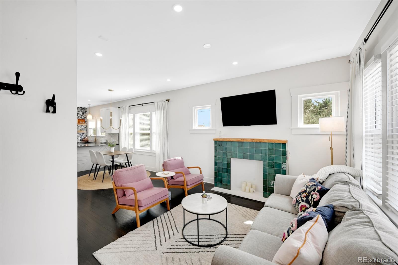 1402 Meade Street Denver, CO 80204 - Photo 6 of 23 a living room with furniture a fireplace and a flat screen tv