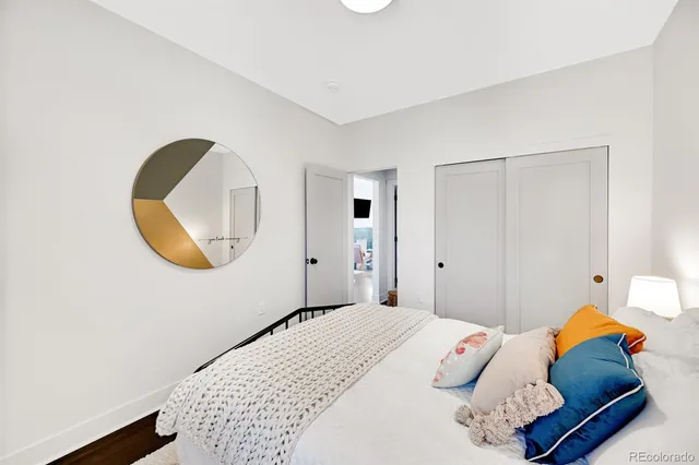 a bedroom with a bed and a mirror