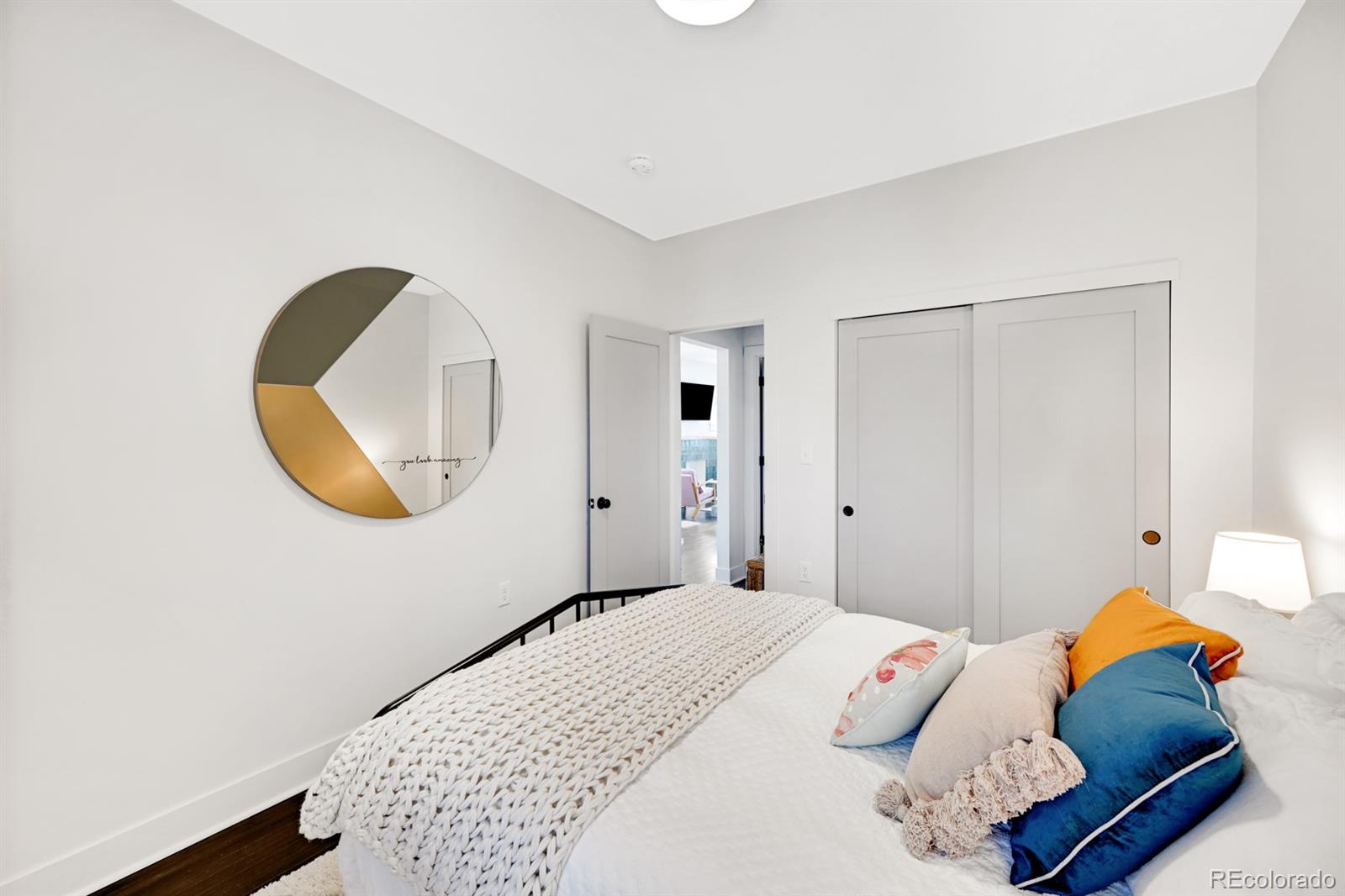 1402 Meade Street Denver, CO 80204 - Photo 9 of 23 a bedroom with a bed and a mirror