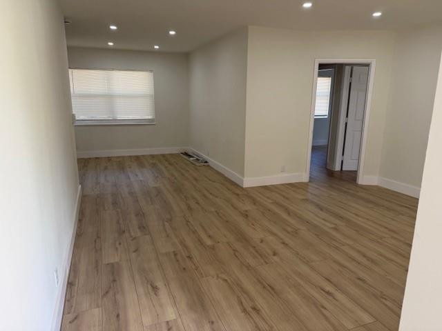 141 Southeast 7th Avenue Boynton Beach, FL 33435 - Photo 2 of 7 an empty room with wooden floor and windows