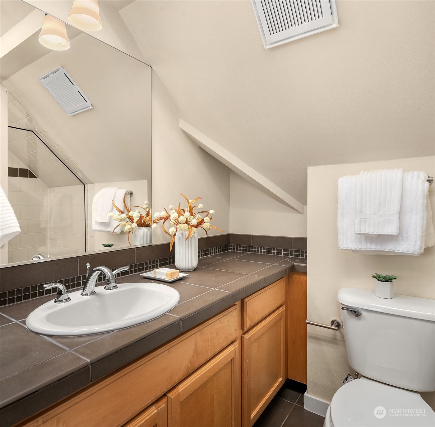 1618 North 46th Street, Unit A Seattle, WA 98103 - Photo 22 of 26 a bathroom with a granite countertop sink and a toilet