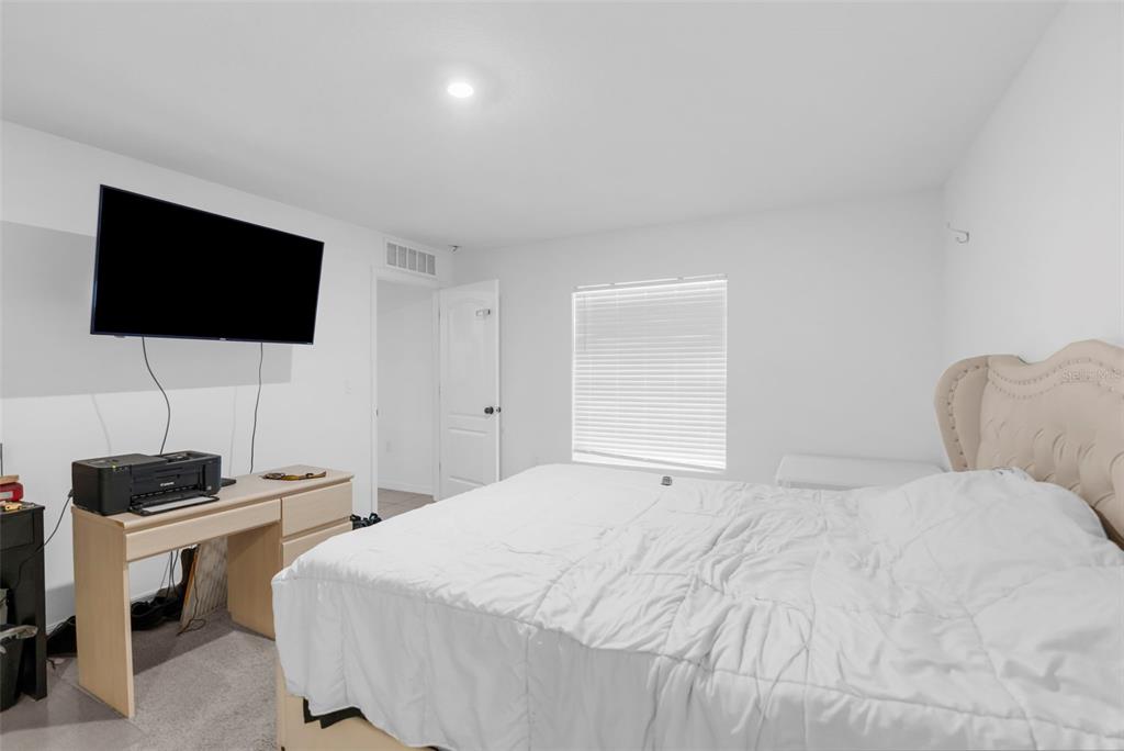 5637 East Tangelo Lane Inverness, FL 34453 - Photo 18 of 23 a bedroom with a bed and a flat screen tv