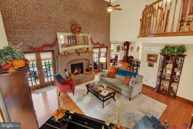 a kitchen with stainless steel appliances granite countertop a sink a stove and a wooden floors