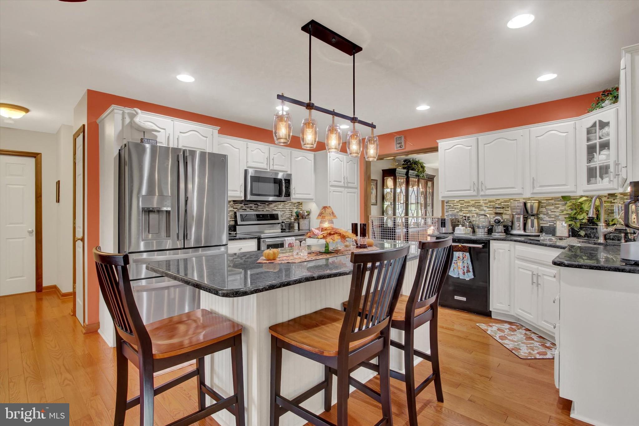 1844 Liberty Road Spring Grove, PA 17362 - Photo 16 of 52 a kitchen with stainless steel appliances kitchen island granite countertop a refrigerator a stove top oven a sink dishwasher and white cabinets with wooden floor