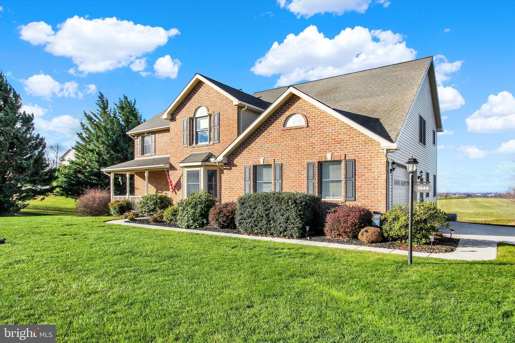 1844 Liberty Road Spring Grove, PA 17362 - Photo 4 of 52 a front view of a house with a yard and potted plants
