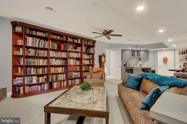 a kitchen with stainless steel appliances granite countertop a stove top oven a sink a dining table and chairs with wooden floor