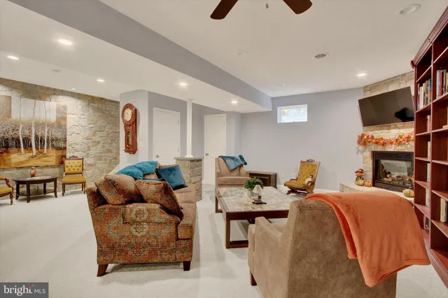 a living room with furniture and a book shelf