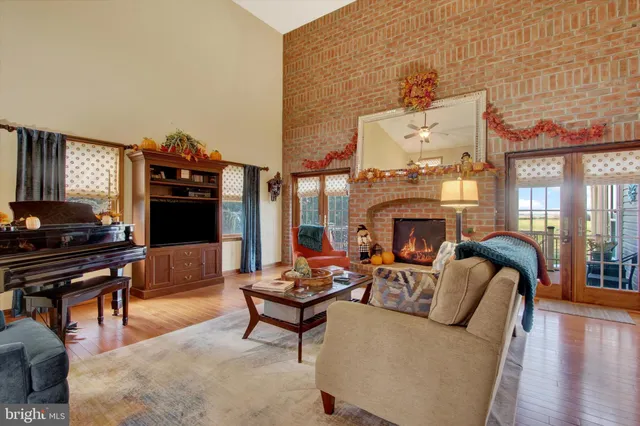 a living room with furniture a fireplace and a piano
