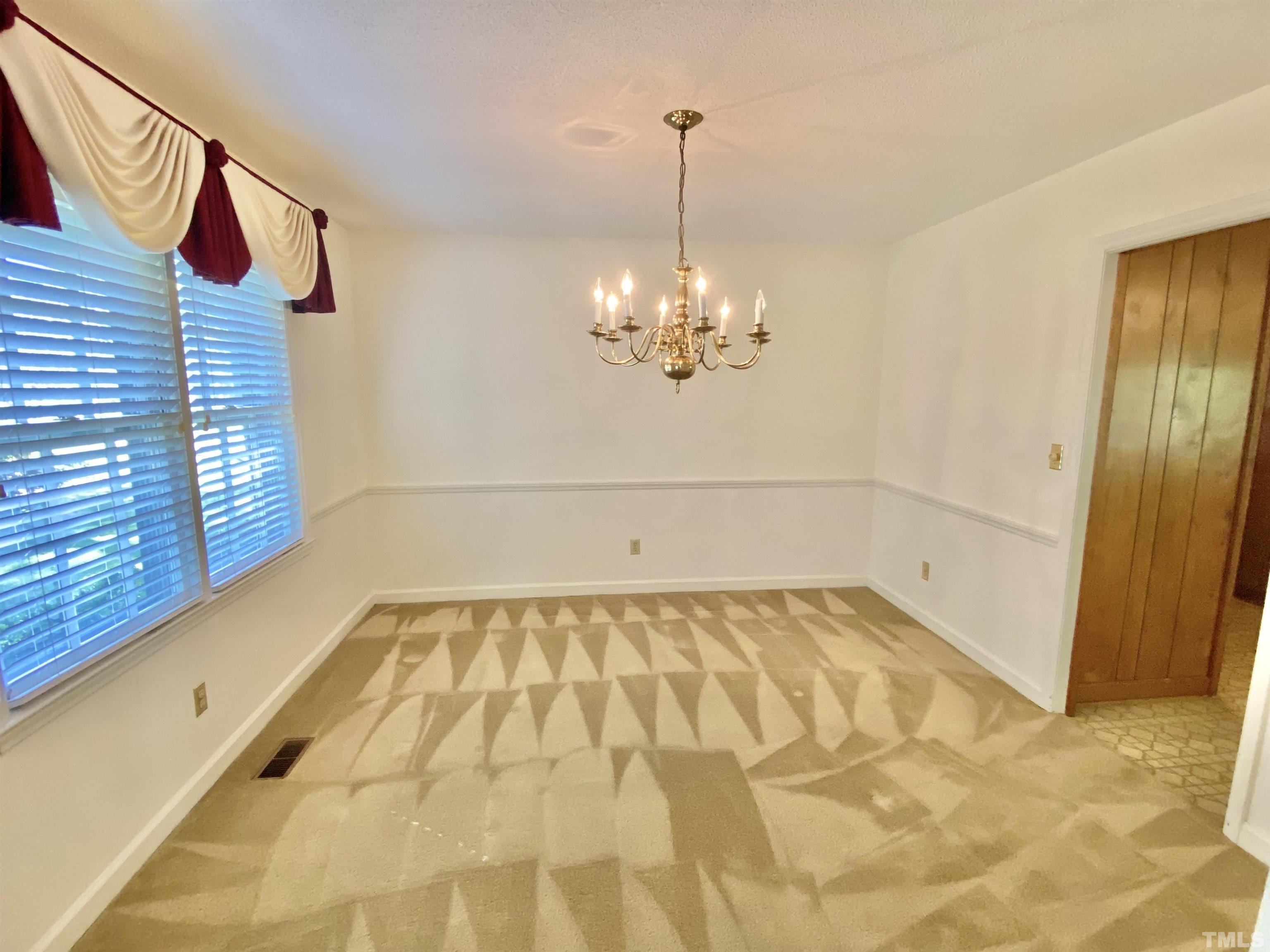 1733 Pearces Road Zebulon, NC 27597 - Photo 14 of 22 a view of a room with a chandelier