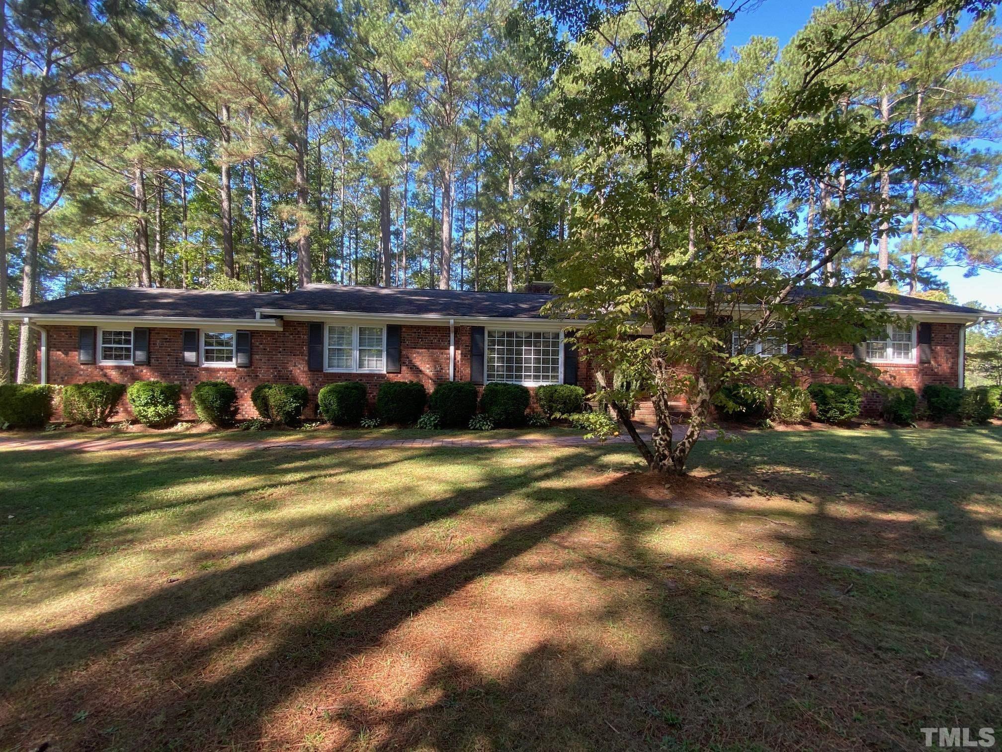 1733 Pearces Road Zebulon, NC 27597 - Photo 3 of 22 a view of a house with swimming pool and a yard