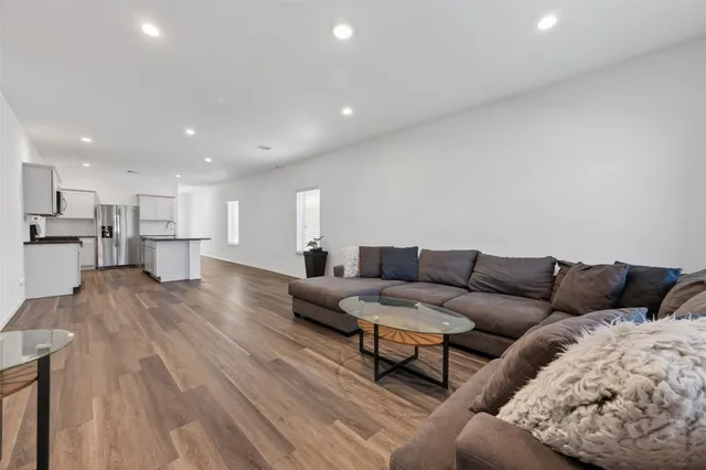 a living room with furniture and kitchen view