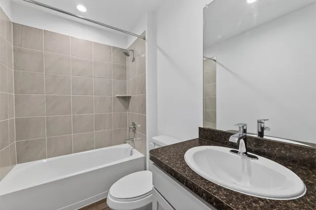 a bathroom with a sink a toilet and bathtub