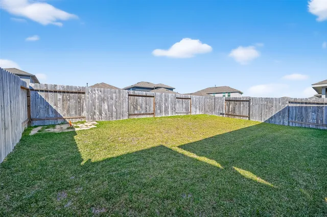 a view of a house with a big yard and large trees