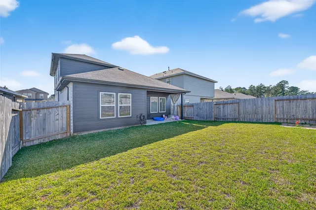 a view of a house with a yard and sitting area