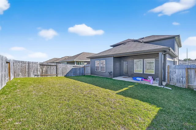 a view of a house with a backyard