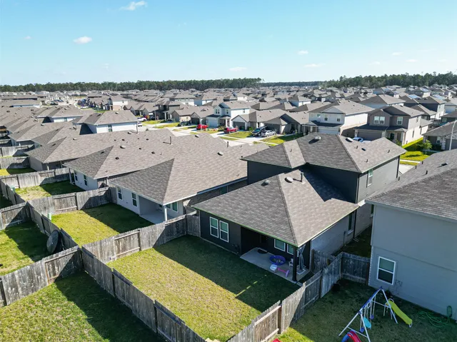 an aerial view of a house with swimming pool and ocean view