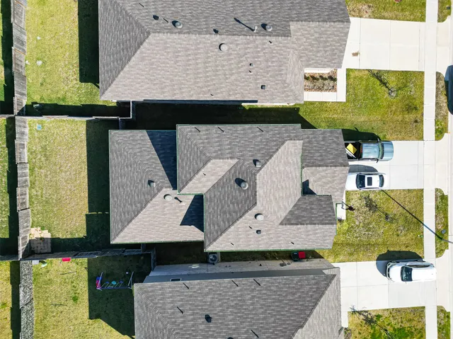 an aerial view of multiple houses with a yard