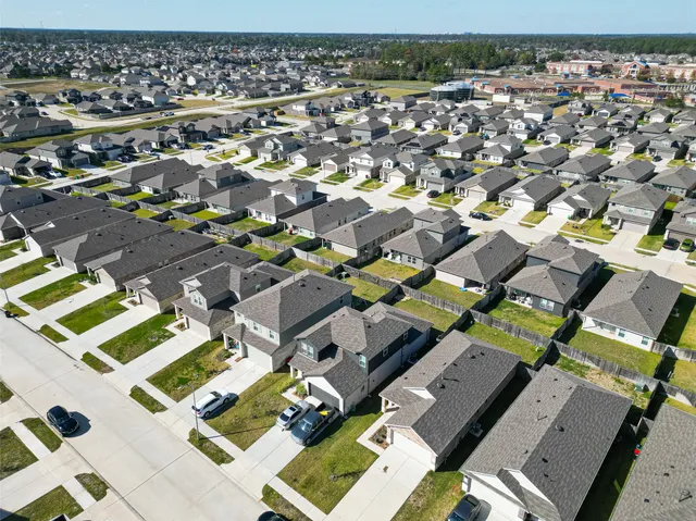 an aerial view of residential houses with outdoor space