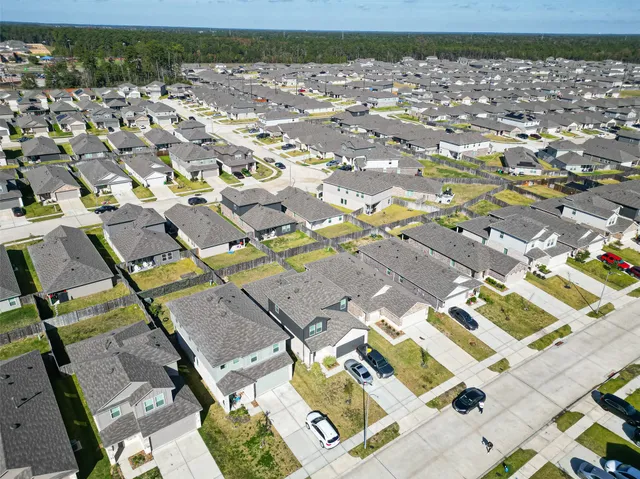 an aerial view of residential houses with outdoor space