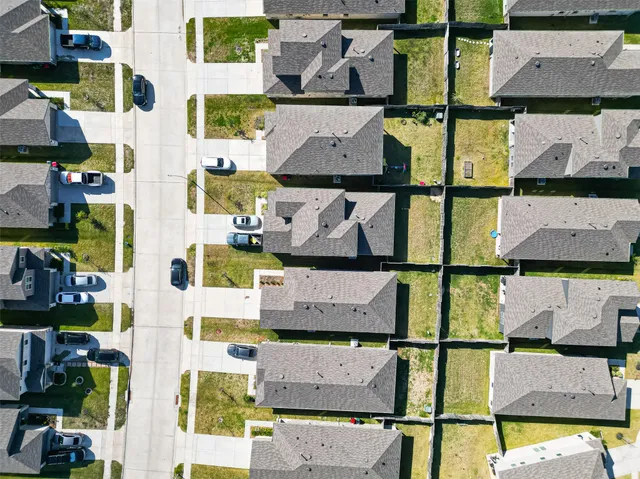 an aerial view of residential houses with outdoor space