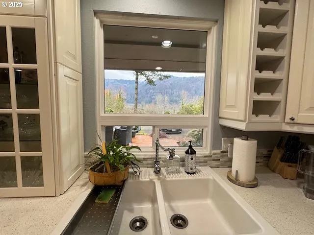 a room with a large window and table chair