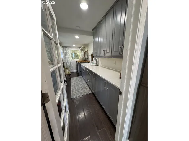 a view of hallway with stainless steel appliances granite countertop cabinets