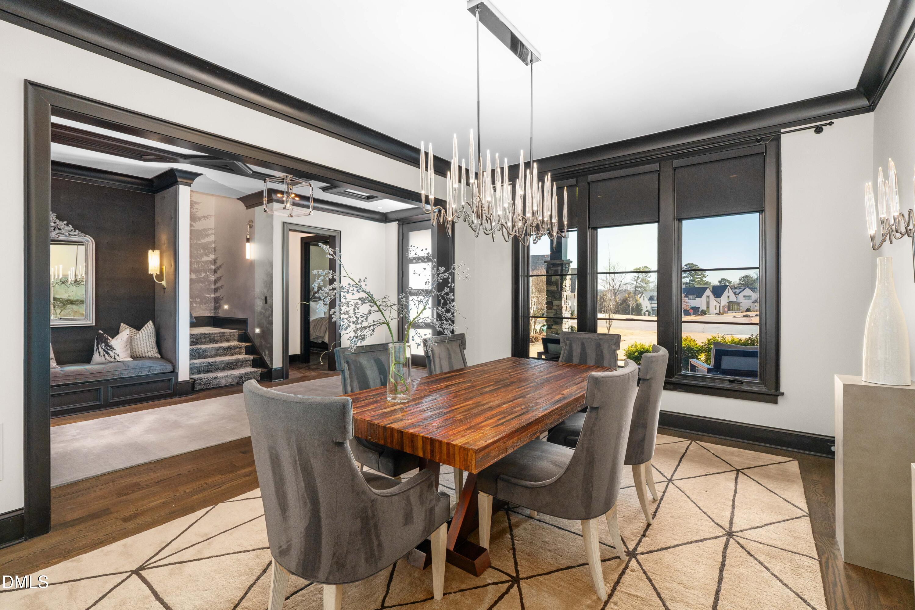 6508 Century Oak Court Raleigh, NC 27613 - Photo 26 of 91 a view of a dining room with furniture large windows and wooden floor