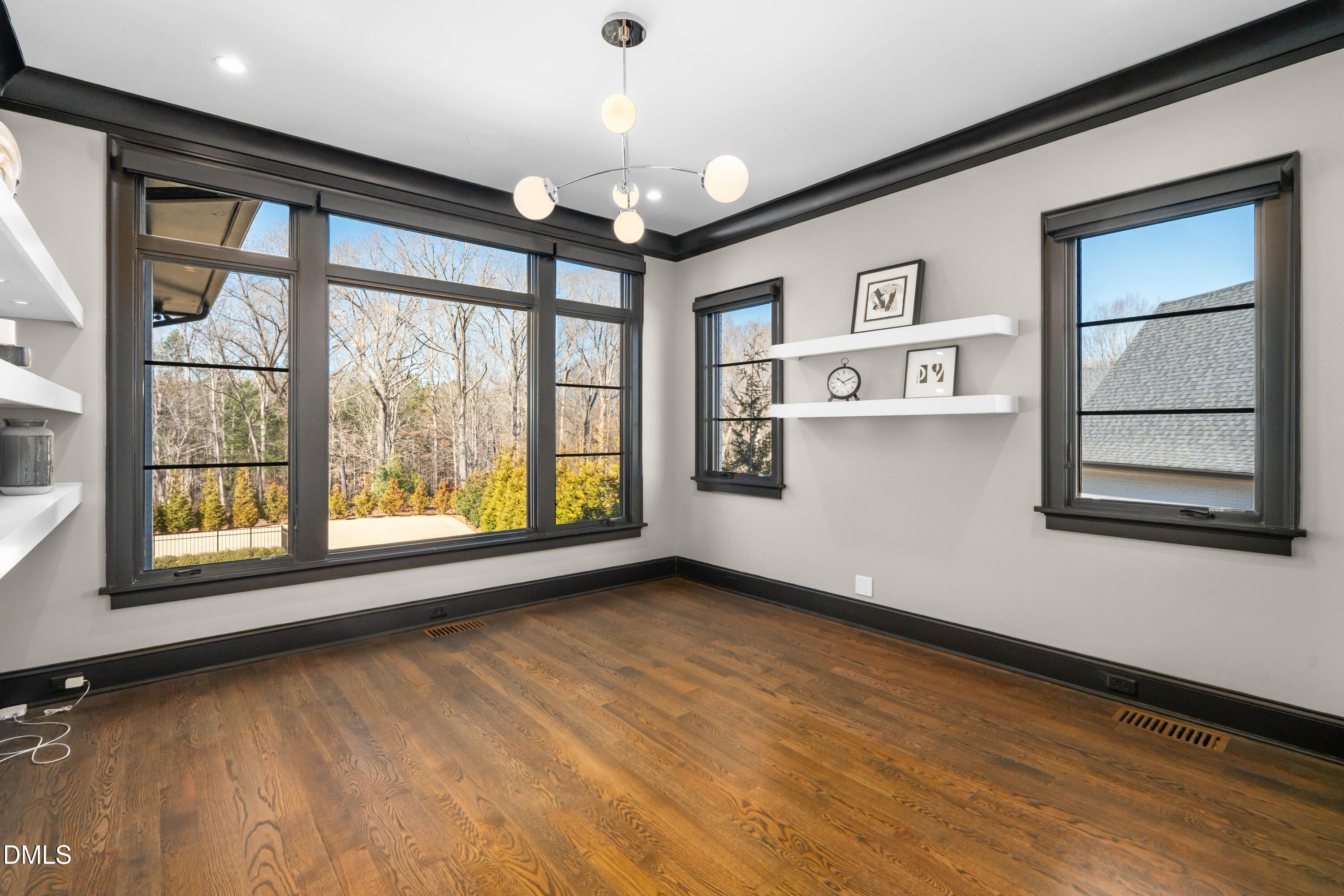 6508 Century Oak Court Raleigh, NC 27613 - Photo 33 of 91 a view of an empty room with a window and wooden floor