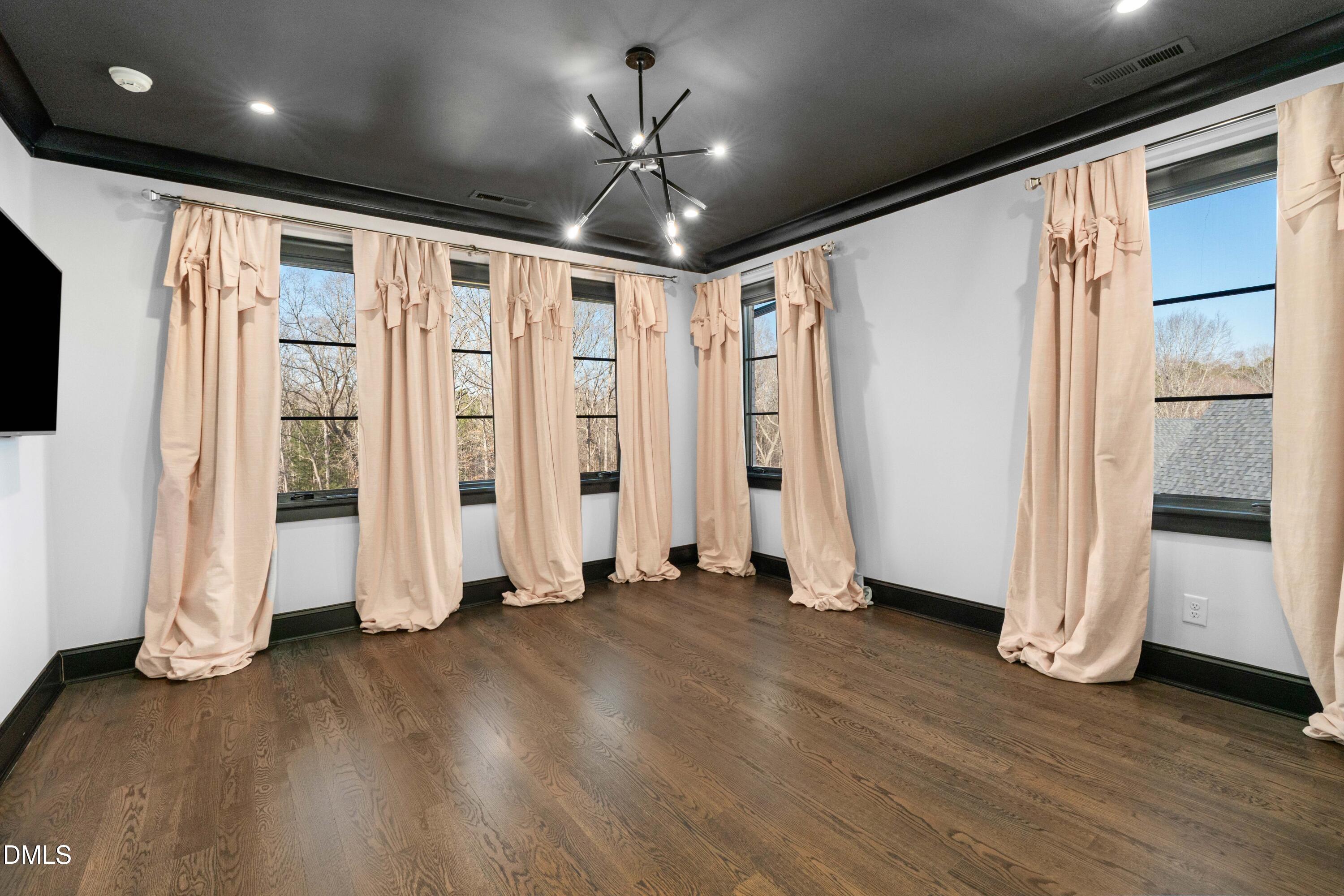 6508 Century Oak Court Raleigh, NC 27613 - Photo 51 of 91 a view of an empty room with wooden floor and a window