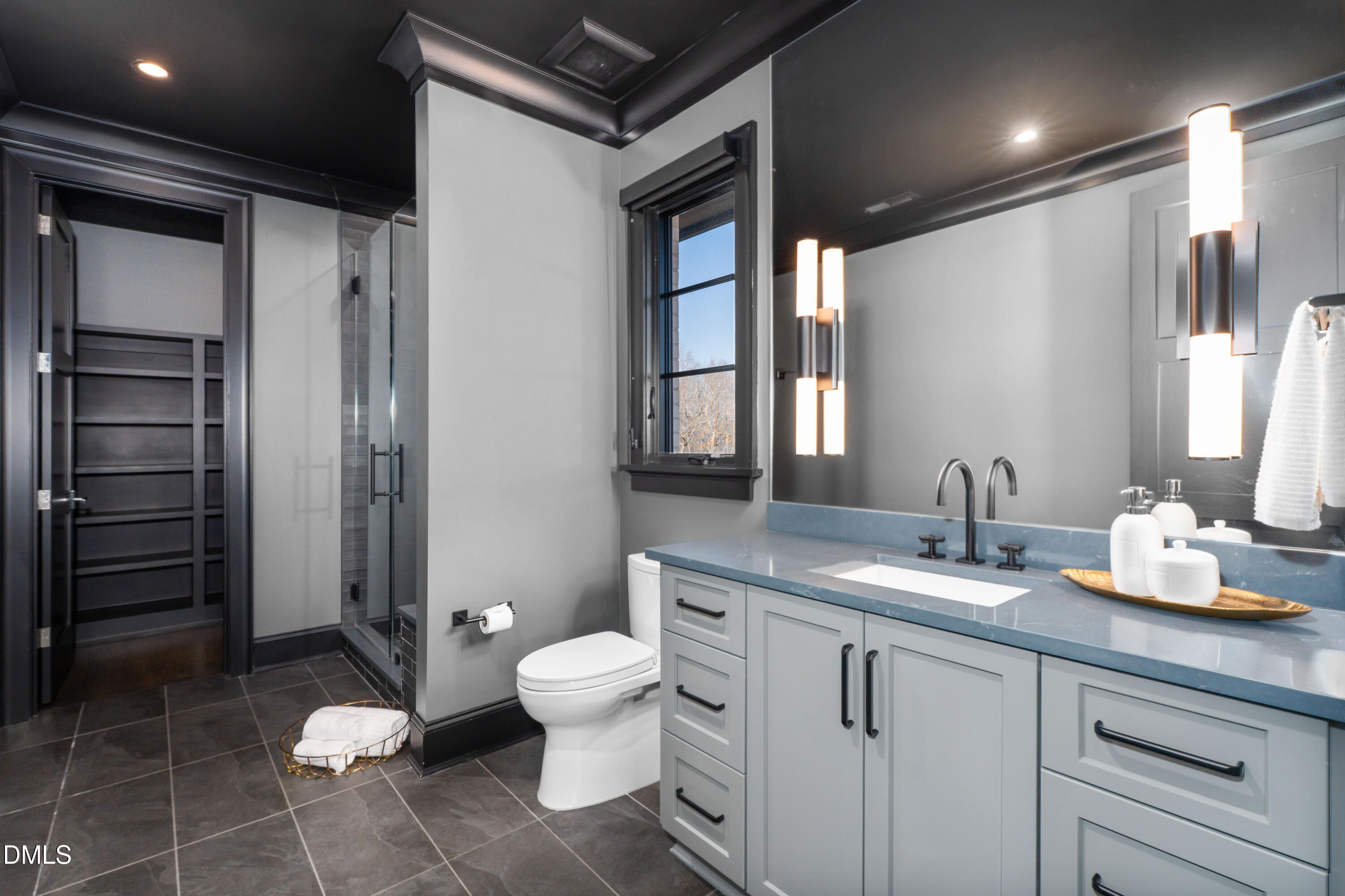 6508 Century Oak Court Raleigh, NC 27613 - Photo 55 of 91 a bathroom with a granite countertop sink a toilet and a mirror