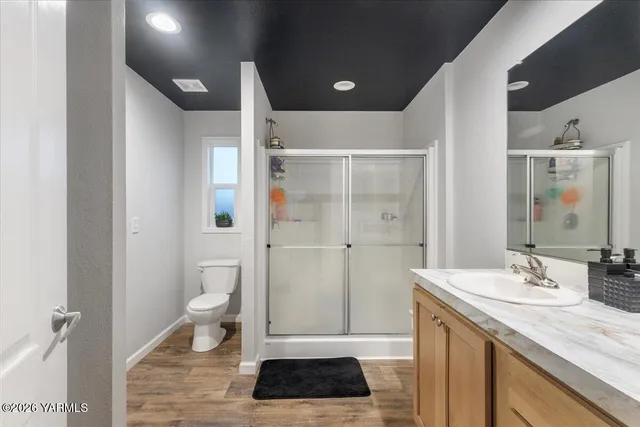 a bathroom with a glass shower door
