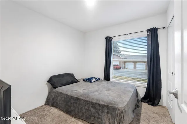 a bedroom with a bed and a window