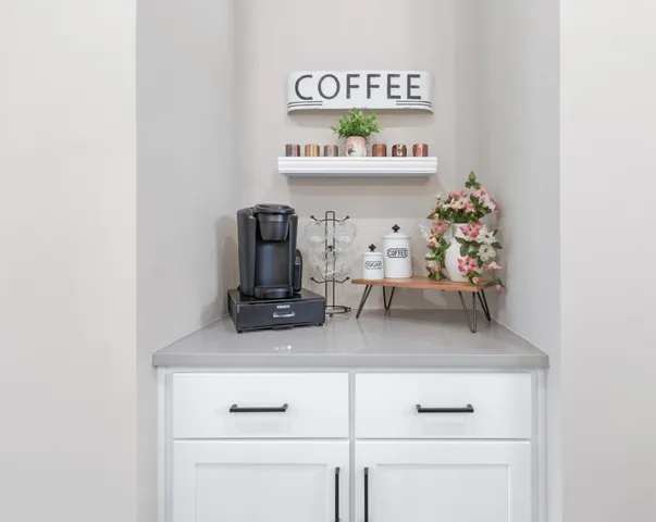 a white kitchen with lots of clutter and stainless steel appliances