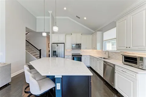 a kitchen with counter and wooden cabinets