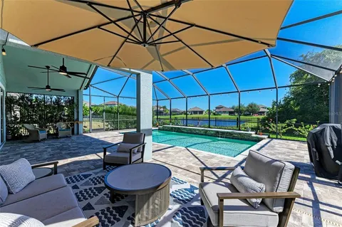 a view of a house with backyard porch and sitting area