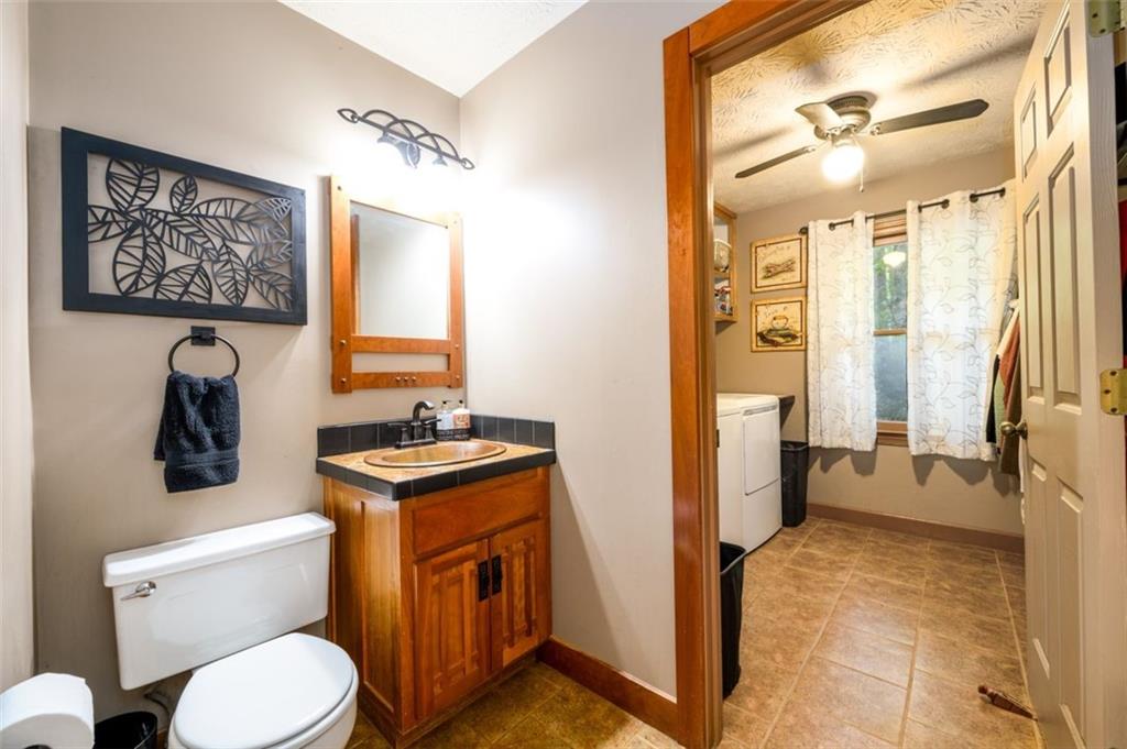 4955-h D H D Atha Road Covington, GA 30014 - Photo 11 of 76 a bathroom with a toilet sink and mirror