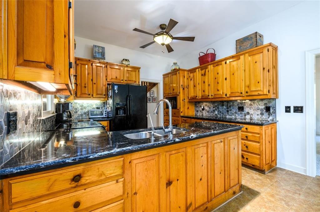 4955-h D H D Atha Road Covington, GA 30014 - Photo 18 of 76 a kitchen with stainless steel appliances granite countertop a sink dishwasher and a refrigerator with wooden floor