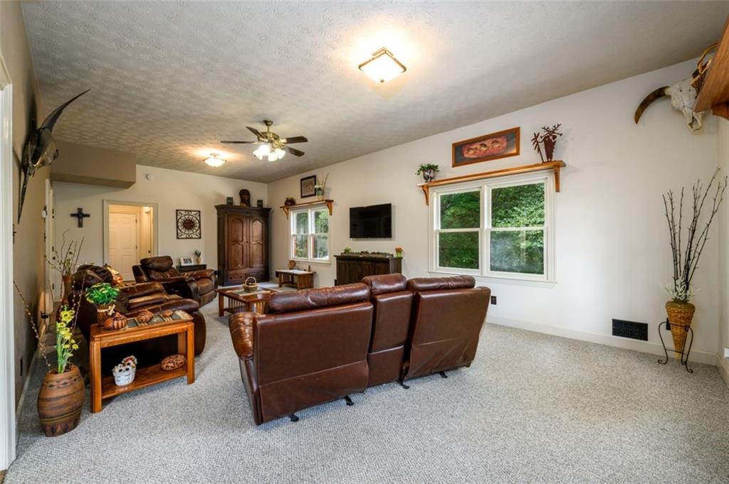 4955-h D H D Atha Road Covington, GA 30014 - Photo 23 of 76 a living room with furniture a flat screen tv and a fireplace