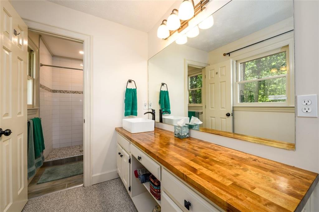 4955-h D H D Atha Road Covington, GA 30014 - Photo 29 of 76 a bathroom with a granite countertop sink and a mirror