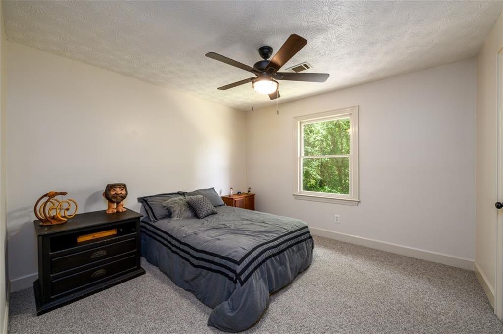 4955-h D H D Atha Road Covington, GA 30014 - Photo 33 of 76 a living room with a bed furniture and a window