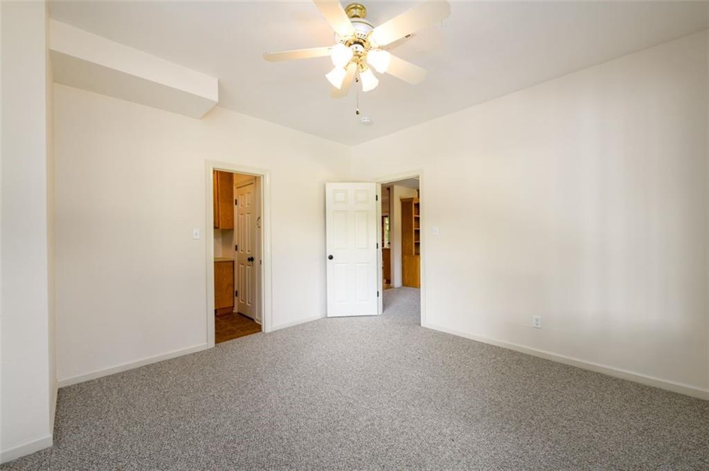 4955-h D H D Atha Road Covington, GA 30014 - Photo 44 of 76 a view of a big room with a ceiling fan and a chandelier fan