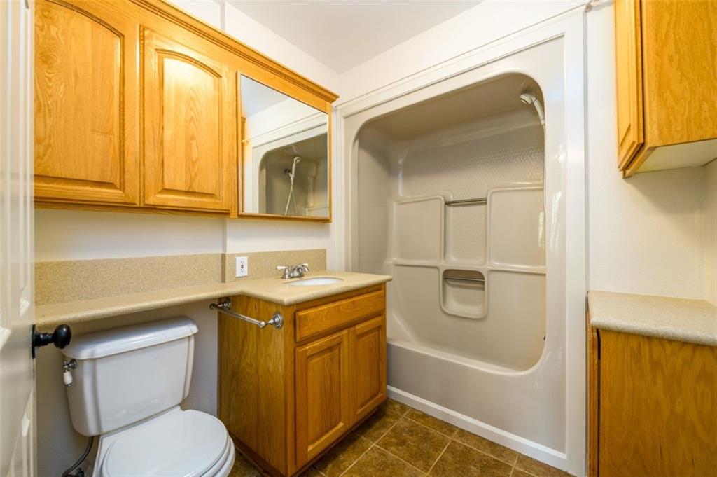 4955-h D H D Atha Road Covington, GA 30014 - Photo 45 of 76 a bathroom with a granite countertop toilet sink and mirror