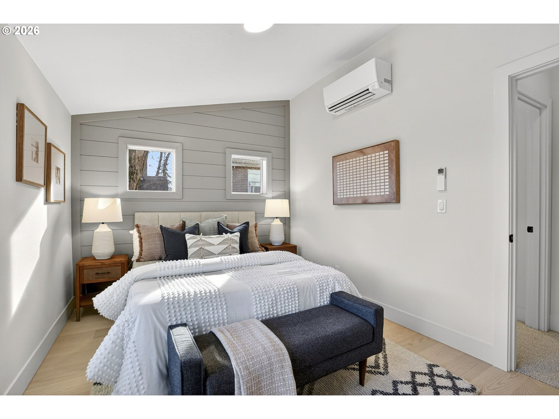 7602 Southeast Carlton Street, Unit B Portland, OR 97206 - Photo 23 of 34 a bedroom with a bed and wooden floor