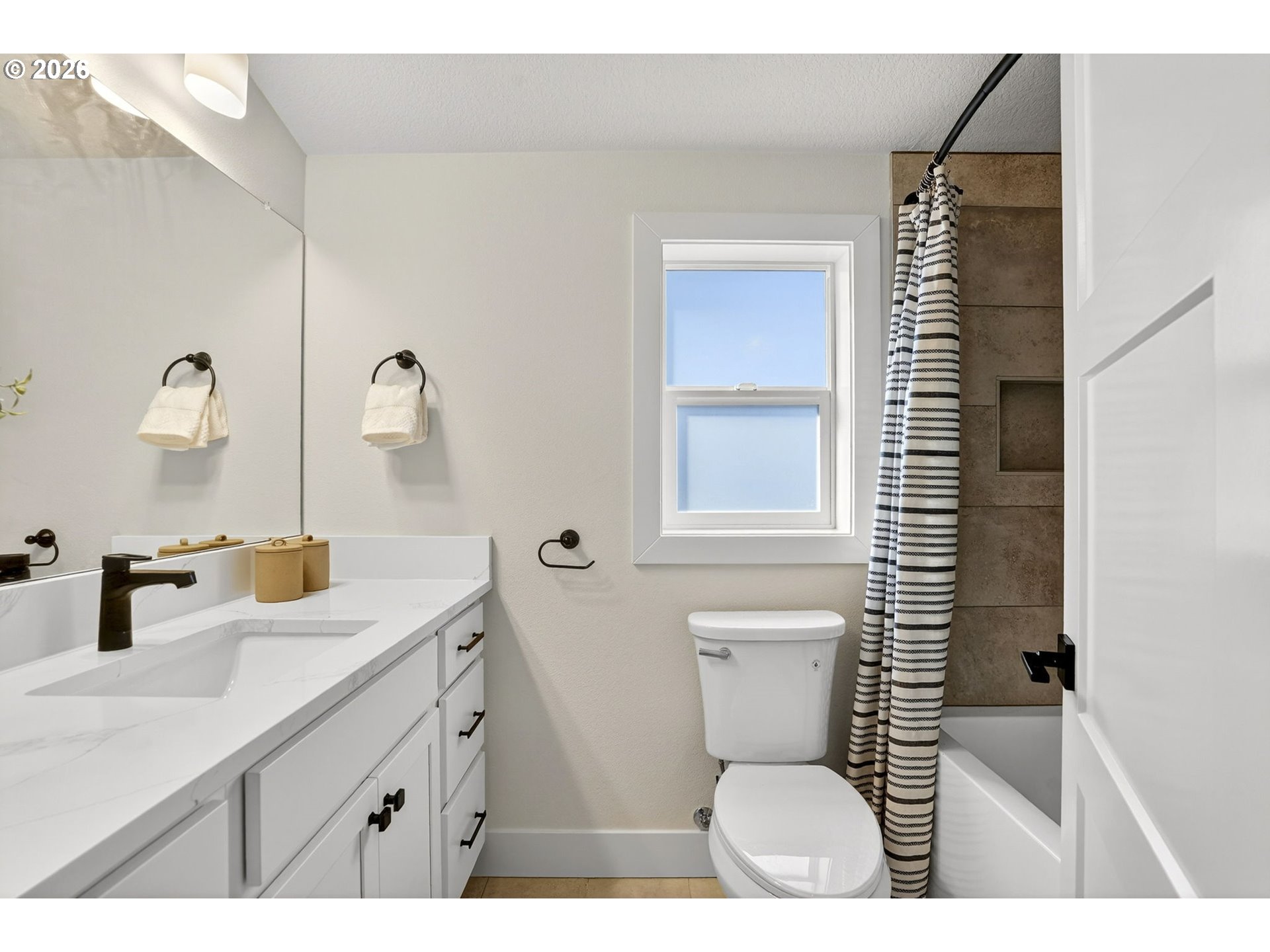 7602 Southeast Carlton Street, Unit B Portland, OR 97206 - Photo 26 of 34 a bathroom with a toilet sink and mirror