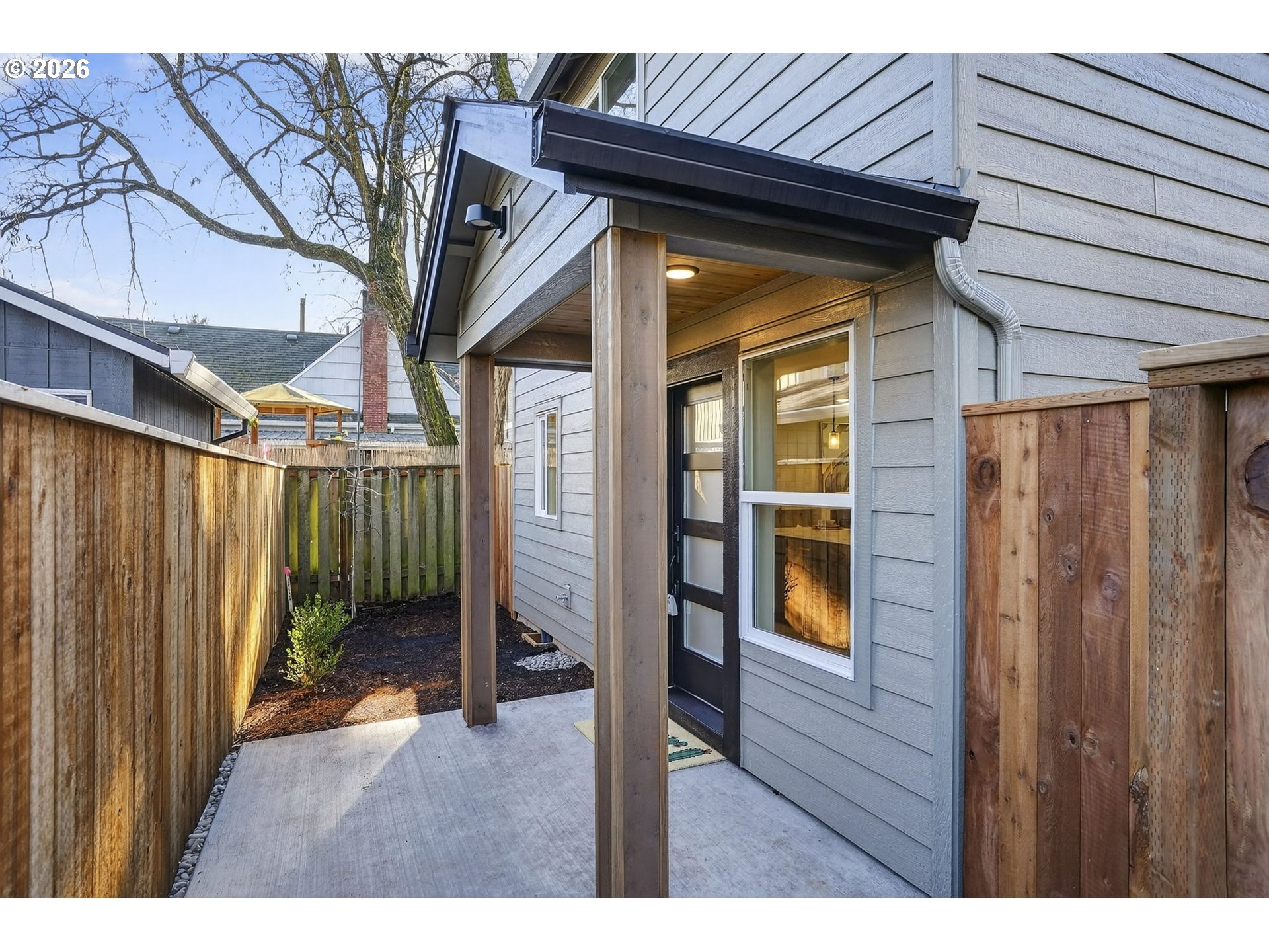 7602 Southeast Carlton Street, Unit B Portland, OR 97206 - Photo 4 of 34 a view of a porch with wooden floor and stairs