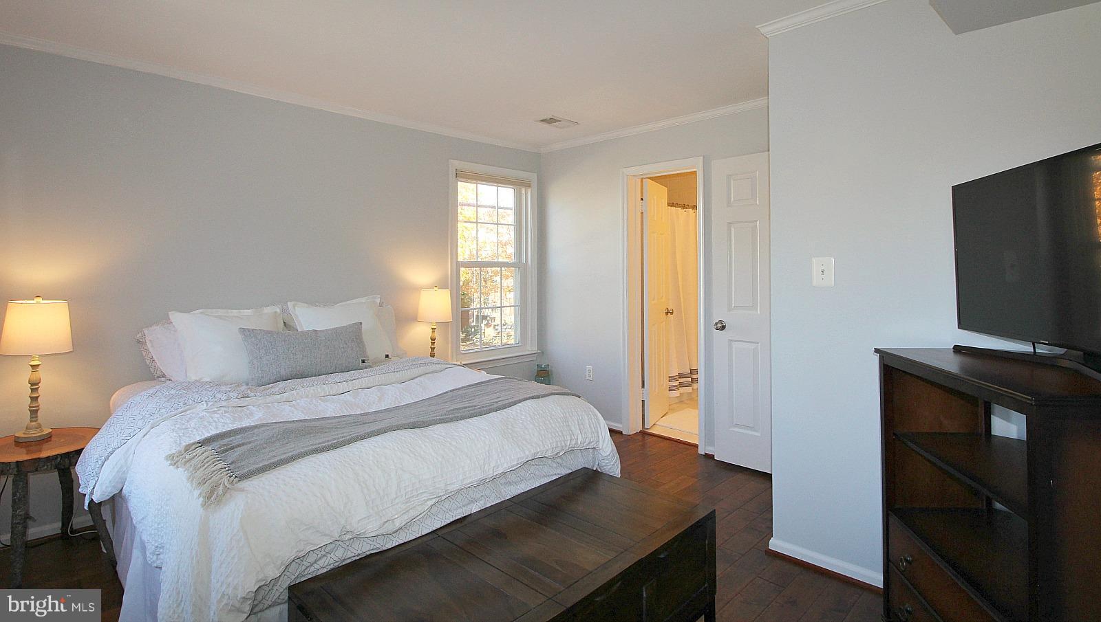 424 West Glebe Road Alexandria, VA 22305 - Photo 14 of 24 a bedroom with a bed and a flat tv screen on a dresser
