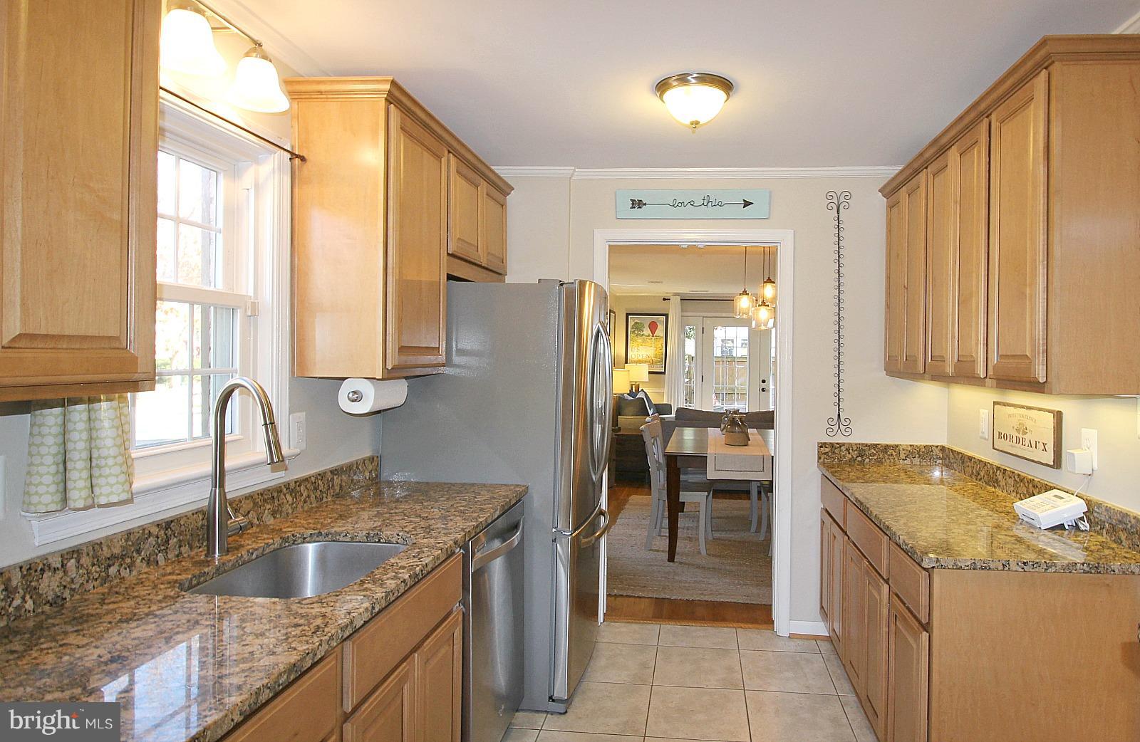 424 West Glebe Road Alexandria, VA 22305 - Photo 6 of 24 a kitchen with granite countertop a sink and a refrigerator