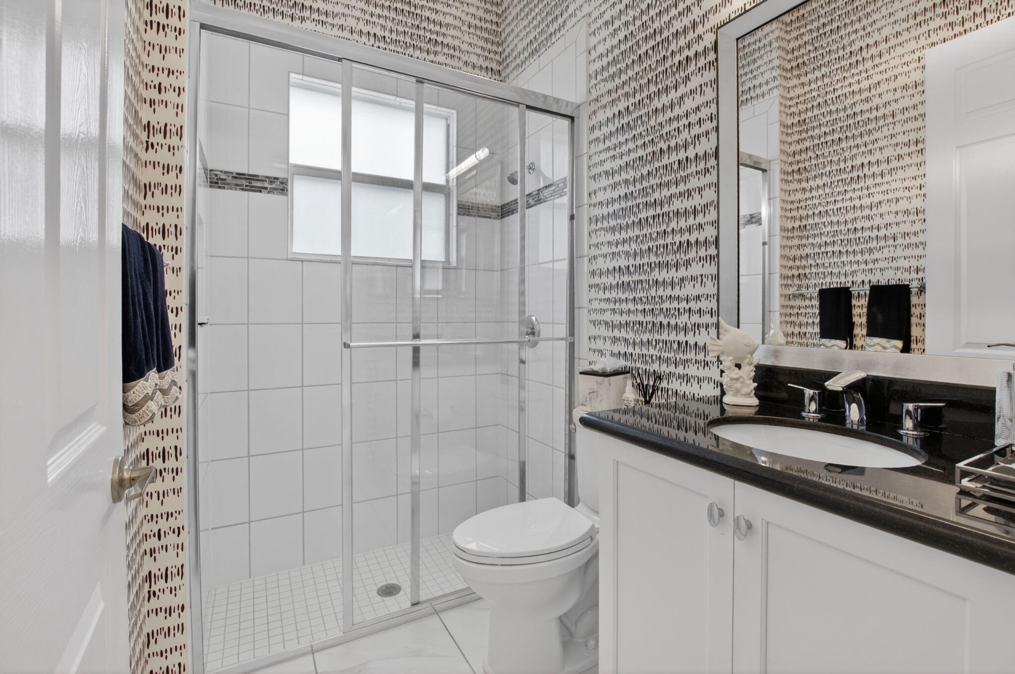 8263 Arabian Range Road Boynton Beach, FL 33473 - Photo 43 of 52 a bathroom with a granite countertop toilet sink and shower