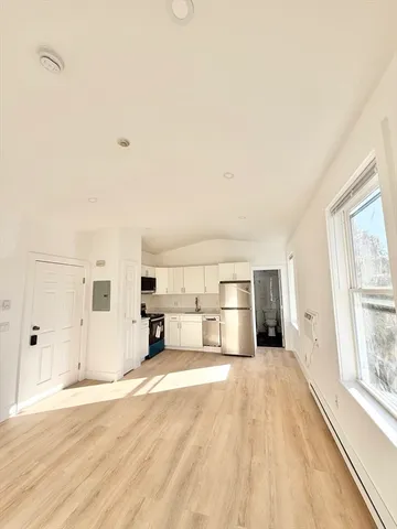 a spacious bedroom with a bed and a cabinets