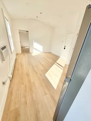 a bedroom with a bed and a rug